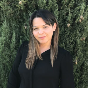 Woman in front of trees