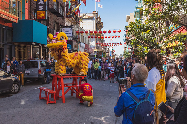 People surrounding Lion Dance dragon at Lunar New Year celebration 